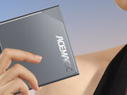 A woman is holding up an ACEMAGIC S1 Mini PC.