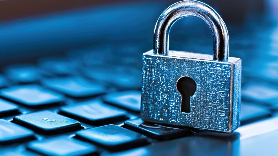 A silver padlock sits on a computer keyboard, symbolizing cybersecurity and data protection.